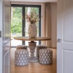 Bespoke upholstered low-level stools sit alongside an eye-catching natural wood table for our private clients family home.#diningroom #diningroomdecor #dinnerparty #diningstyle #homedecor #interiordesign #luxuryhomes #luxuryinteriordesign #texturedwallpaper #bespokefurniture #bespoke #tailormade